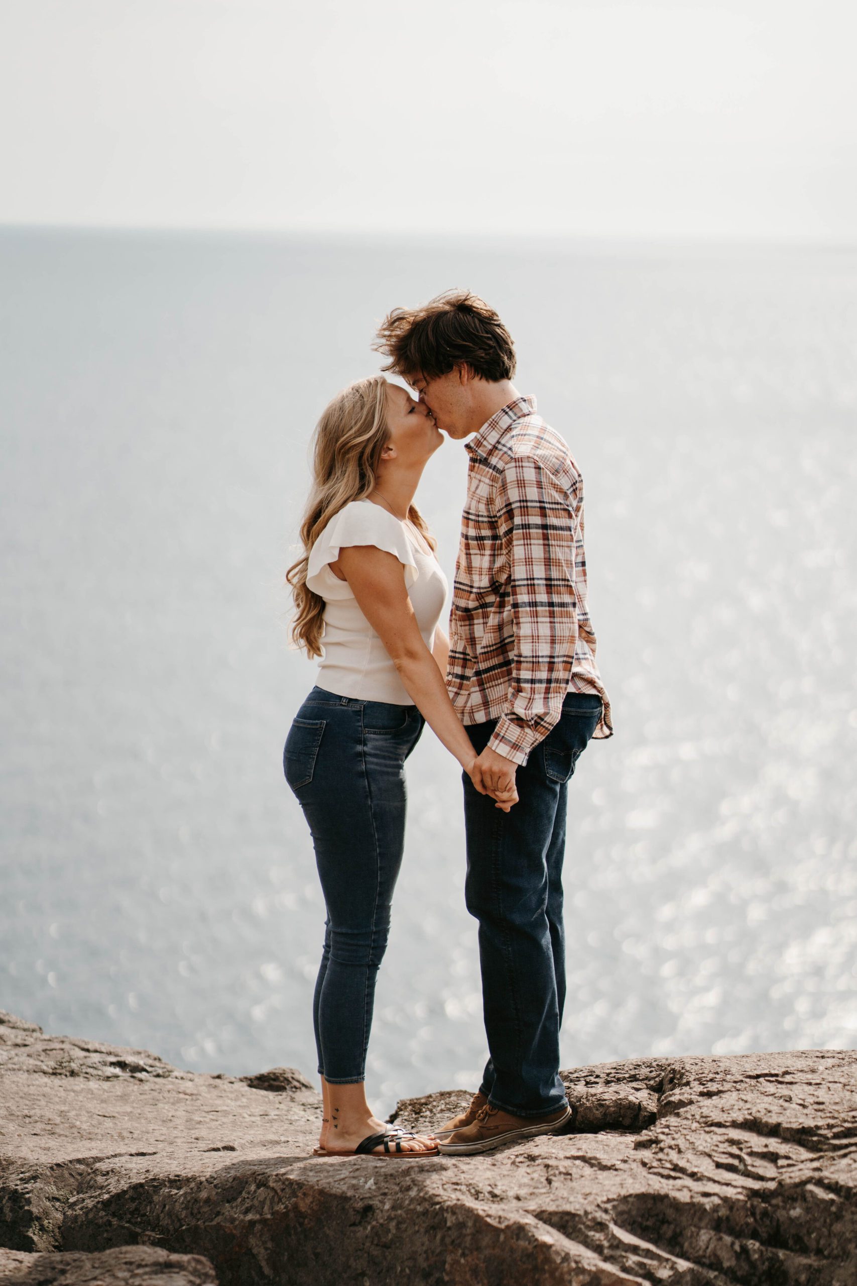 Minnesotan engaged couple kissing at Palisade Head in Northern Minnesota