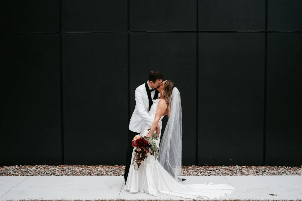 winter wedding at catalyst naturelink bride and groom portraits outside the venue with snow on the ground