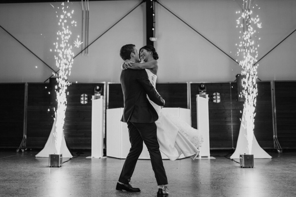 Bride and groom share a first dance with sparklers at their wedding at quincy hall in minneapoils minnesota