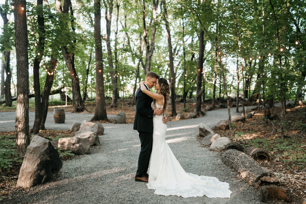 Bride and groom dancing under the string lights on their wedding day at Howling Moon Weddings & Events.