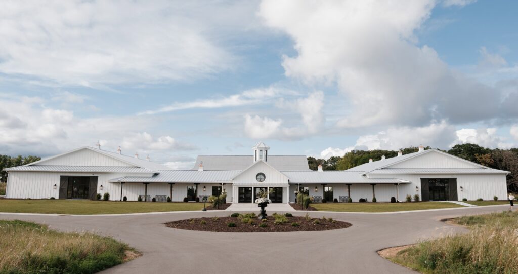 Exterior photo of the entrance at Equestria West by Bavaria Downs which is a modern, luxury wedding venue located in Chaska Minnesota. The photo was taken by Lulle Photo and Film on a summer wedding day.