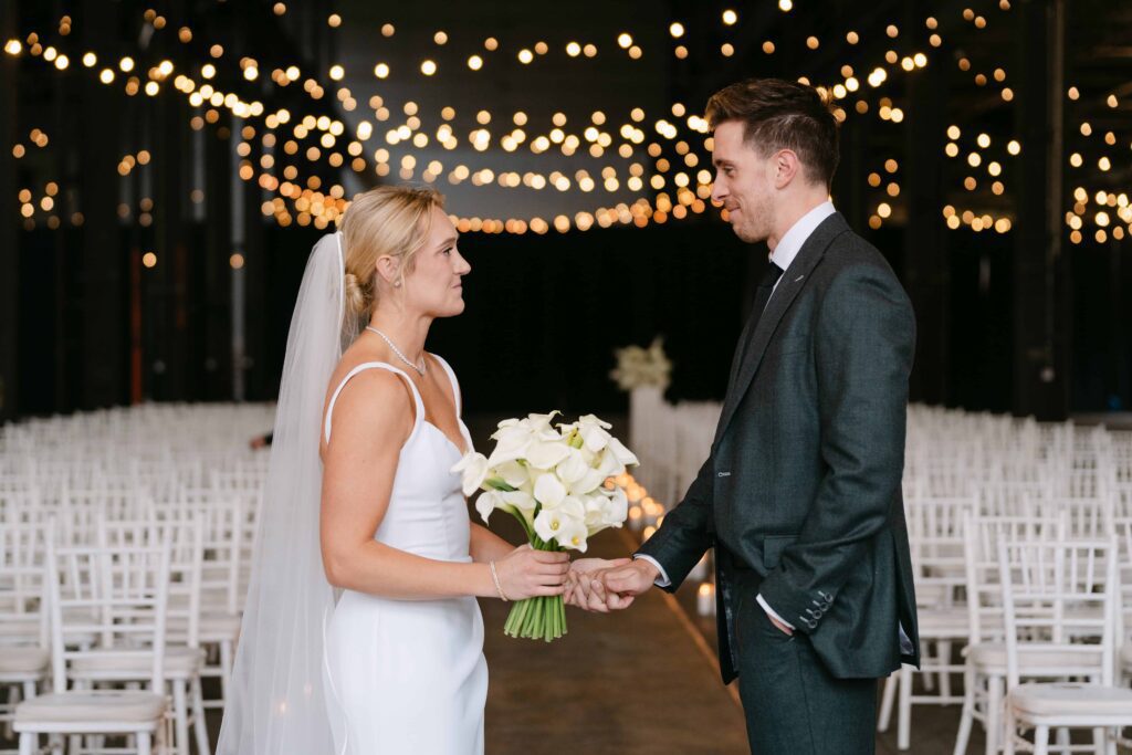 Bride and groom has their first look in the ceremony space at their wedding venue at Northern Pacific Center in Brainerd Minnesota